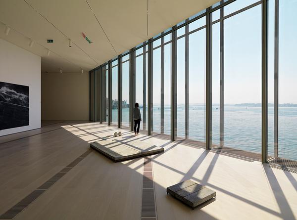 The building extends out and over the waterfront, creating impressive views across the sea