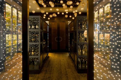 Gold is abundant in the restaurant design and features prominently in the wine cellar / Blue Sky Hospitality