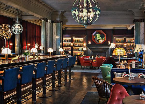 The bar was designed by Martin Brudnizki and features a wooden bar and a roaring fire