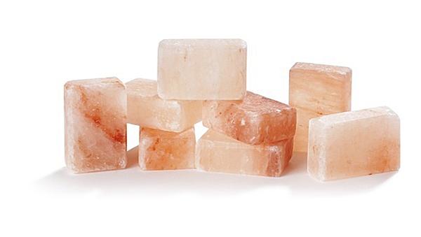 Warm salt stones massage the body before an exfoliation