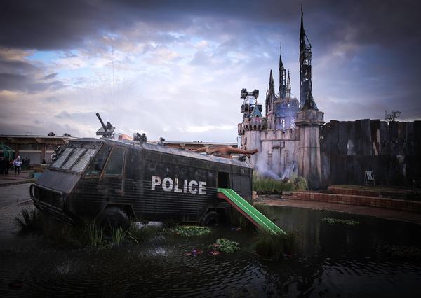 Cinderella’s Castle is the crowning glory at Dismaland. Nearby, an armoured riot van from Northern Ireland boasts the addition of a kids’ slide / PHOTOS: North Somerset Council