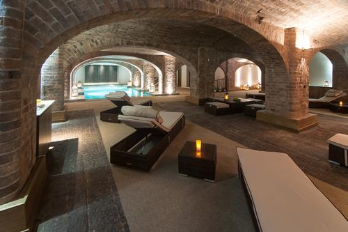 The five treatment rooms are encased in exposed brickwork arches and there is a Roman bath-style pool and an aqua thermal zone / Titanic Hotel Liverpool