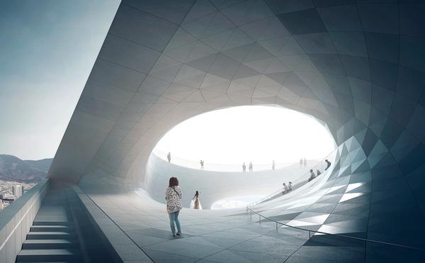 The Busan Opera House in South Korea features an angled roof that curves down to meet the ground, allowing visitors to climb up to a public space on the rooftop 