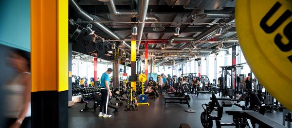 The gym at Stratford is a colourful, light space, with brightly striped pillars