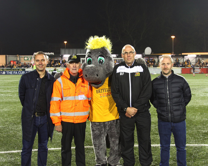 Replay's Garry Martin and Steven Spence are joined by Iggy, Maidstone United’s mascot, Barry Fenn and Tom Smith from Maidstone United FC at the game / 