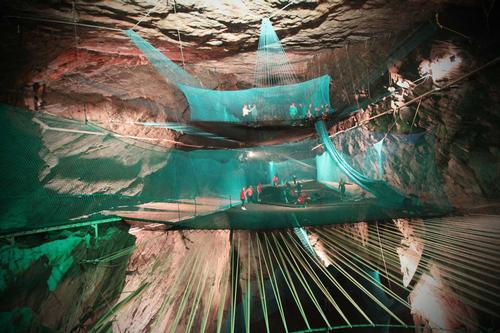 The trampolines are suspended above an underground chasm accessible by train ride / Big and Clever Adventures