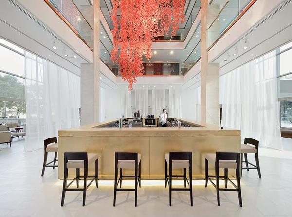 The red ceiling sculpture by Jacopo Foggini creates a dramatic contrast to the all-white interior