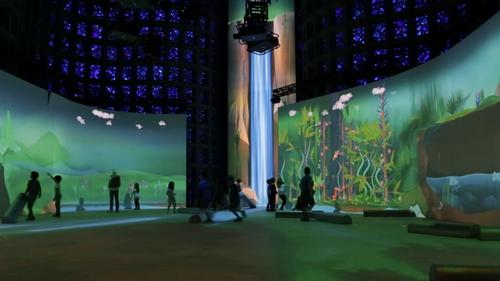 The Great Hall’s cobalt blue dalle-de-verre glass and concrete walls are designed to give the illusion of being in deep space. / Ennead Architects