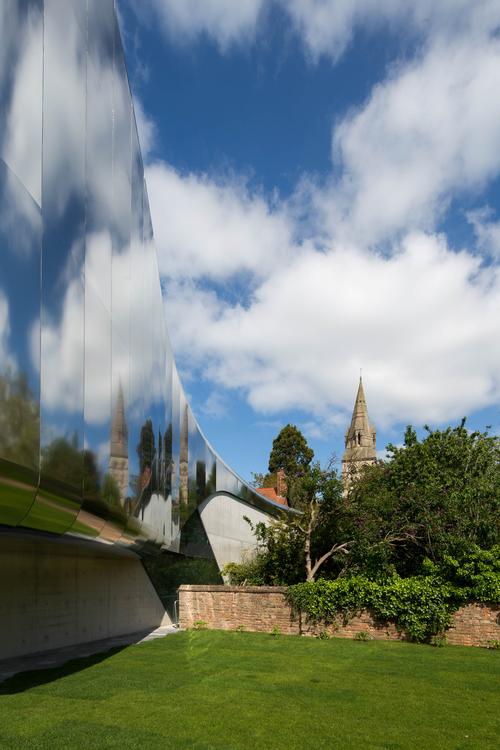 The building has stainless steel cladding to reflect natural light and give the building an ephemeral quality / ZHA / Luke Hayes