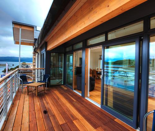 The property uses natural materials of glass, local stone, white oak and walnut / Portavadie