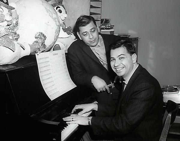 Songwriters Richard and Robert Sherman rehearse their song, It’s a Small World, at the Walt Disney Studios in this 1964 photo / PHOTOS: Disney Parks