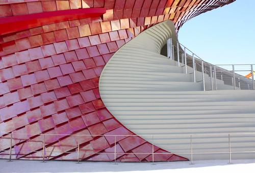 A grand staircase clad in a white mosaic tile guides visitors to the upper levels / Studio Libeskind