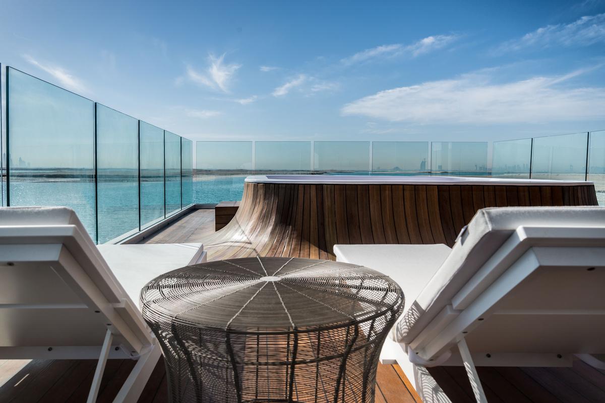 The outdoor deck features a glass-bottomed Jacuzzi / Kleindienst Group