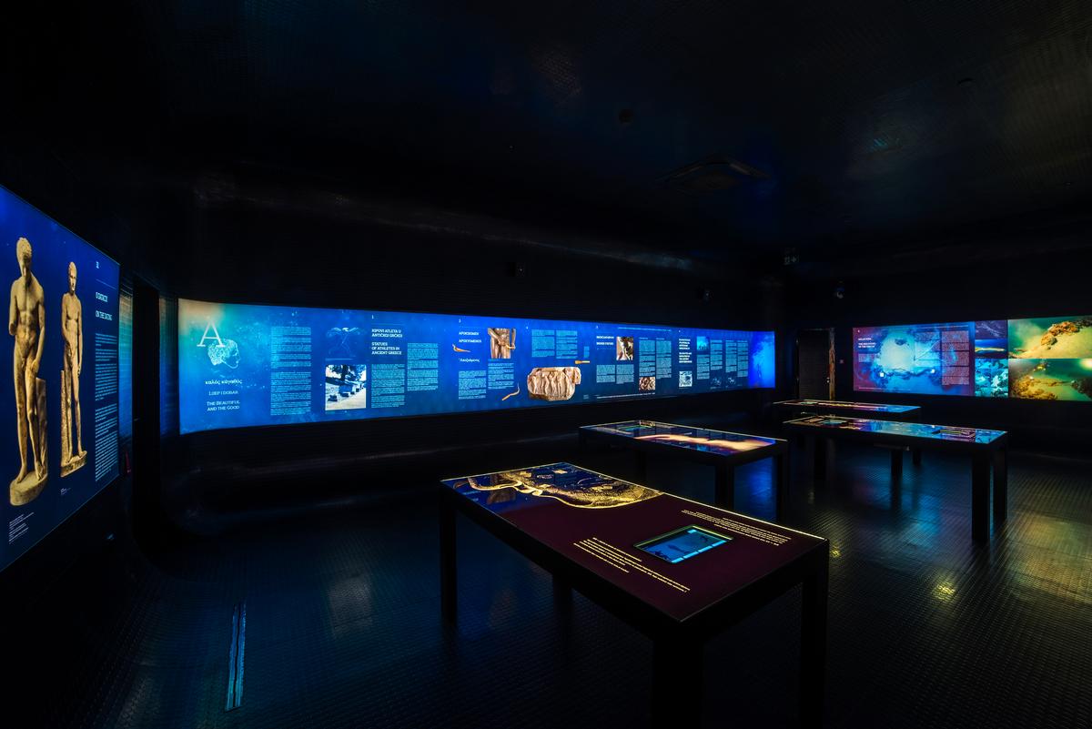 Within the dark area, visitors can learn the history, context, discovery, and restoration of Apoxyomenos via illuminated displays detailing the statue’s past / Museum of Apoxyomenos