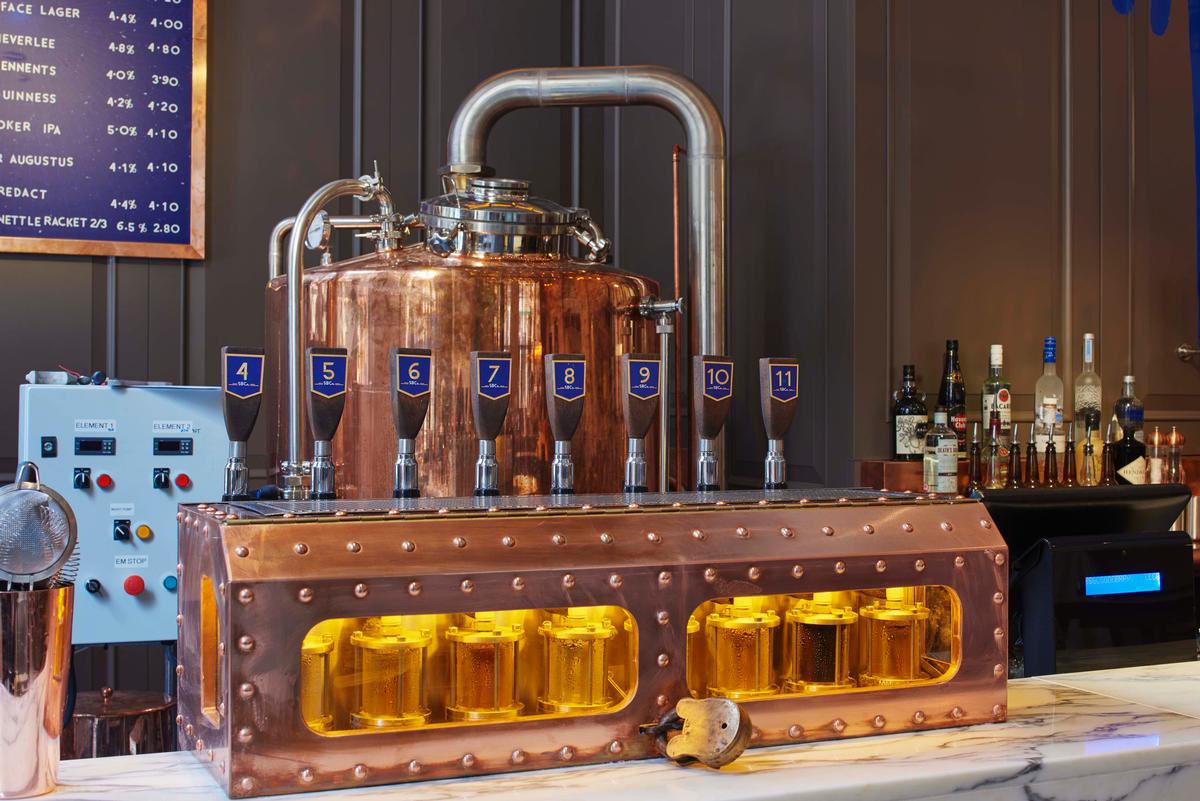 The copper vessels of the brewery are an eye-catching addition to the former bank building / James Harris