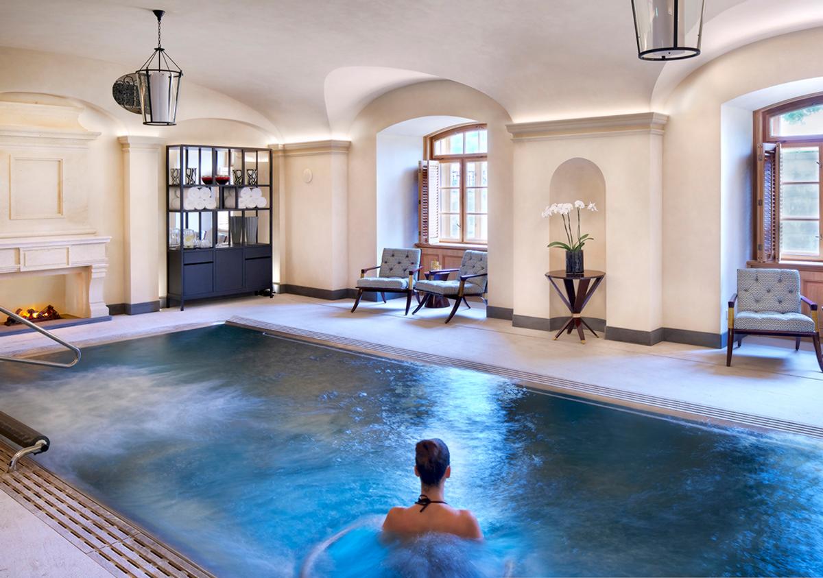 The spa features a sauna, steam bath and vitality pool with waterfall, massage jets and hydrotherapy, surrounded by lounge chairs and a fireplace The spa features a sauna, steam bath and vitality pool with waterfall, massage jets and hydrotherapy, surrounded by lounge chairs and a fireplace