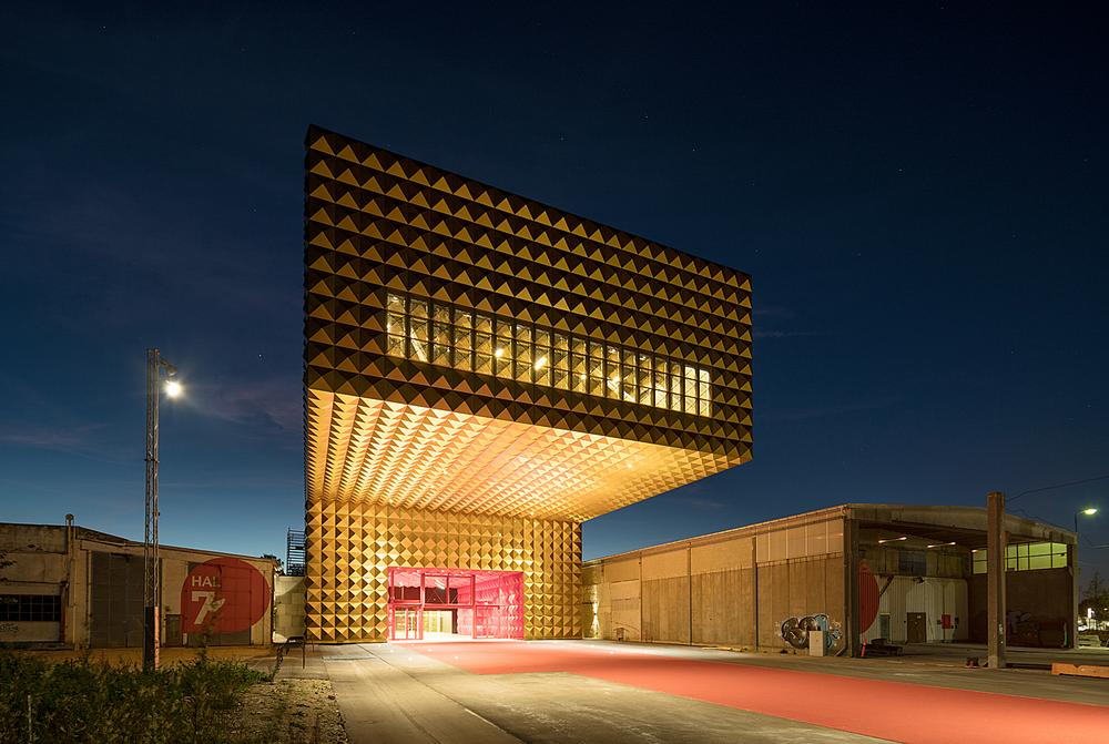 The recently opened Ragnarock rock museum in Roskilde, Denmark features a gold studded façade, bold red interiors and a cantilevered auditorium / Photos of Ragnarock: © Ossip van Duivenbode