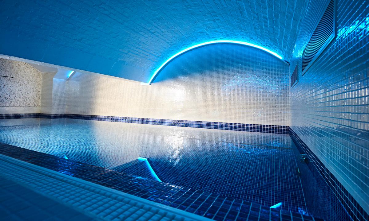 The urban retreat features an indoor pool with low-level lighting and an accompanying hydrotherapy pool / Bristol Harbour Hotel & Spa