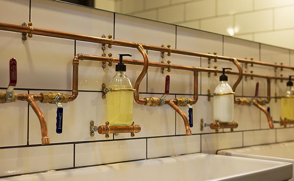 Industrial luxe: The changing rooms feature exposed copper piping as a design feature
