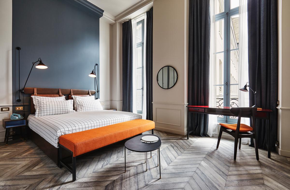 The historical grandeur is echoed in the bedrooms through cornicing, panelling and reclaimed oak chevron timber flooring / The Hoxton, Paris