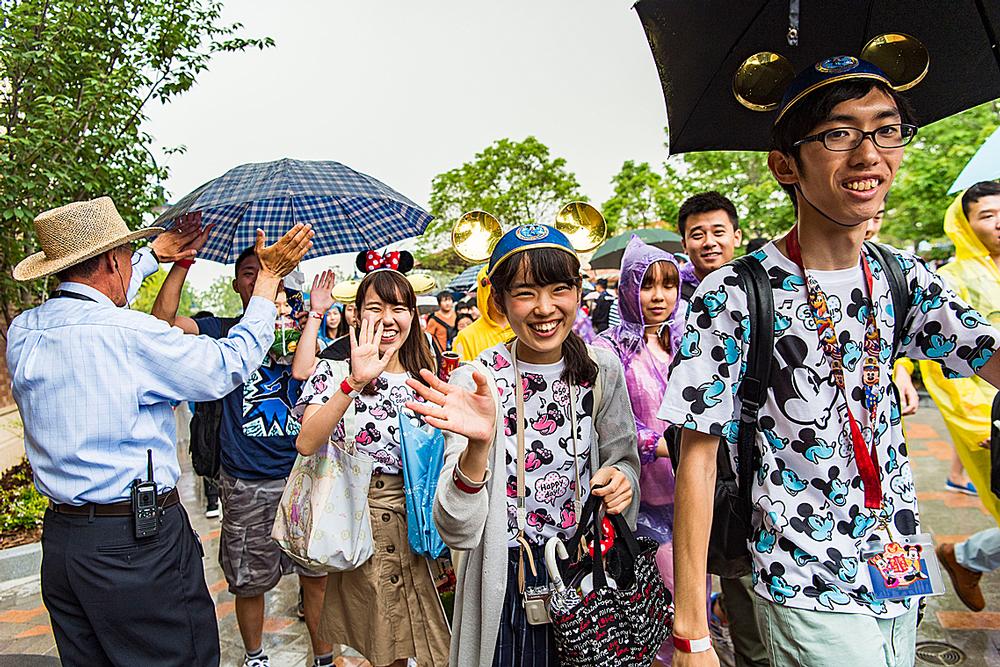 Umbrellas go up as the sun comes out as visitors enjoy the first Disney park in mainland China