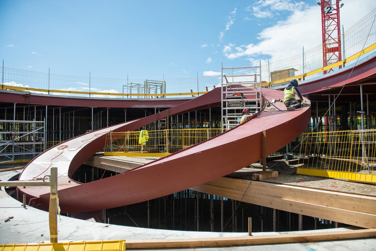 The newly released photographs show the building’s circular staircase and its sinuous façade structure rising at the construction site / Luca Delachaux