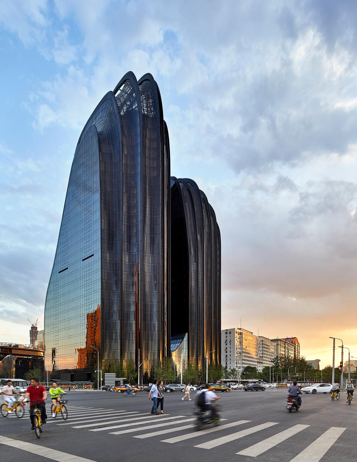 The 220,000sq m (2.3 million sq ft) Chaoyang Park Plaza is formed of ten organically-shaped buildings, each shaped by smooth curved surfaces of black and white / Hufton + Crow