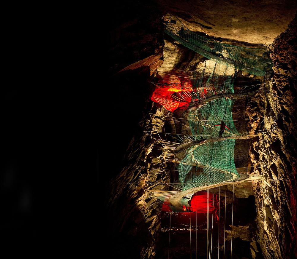 Inside the cavern, three vast trampolines form levels linked by slides, tunnels and walkways