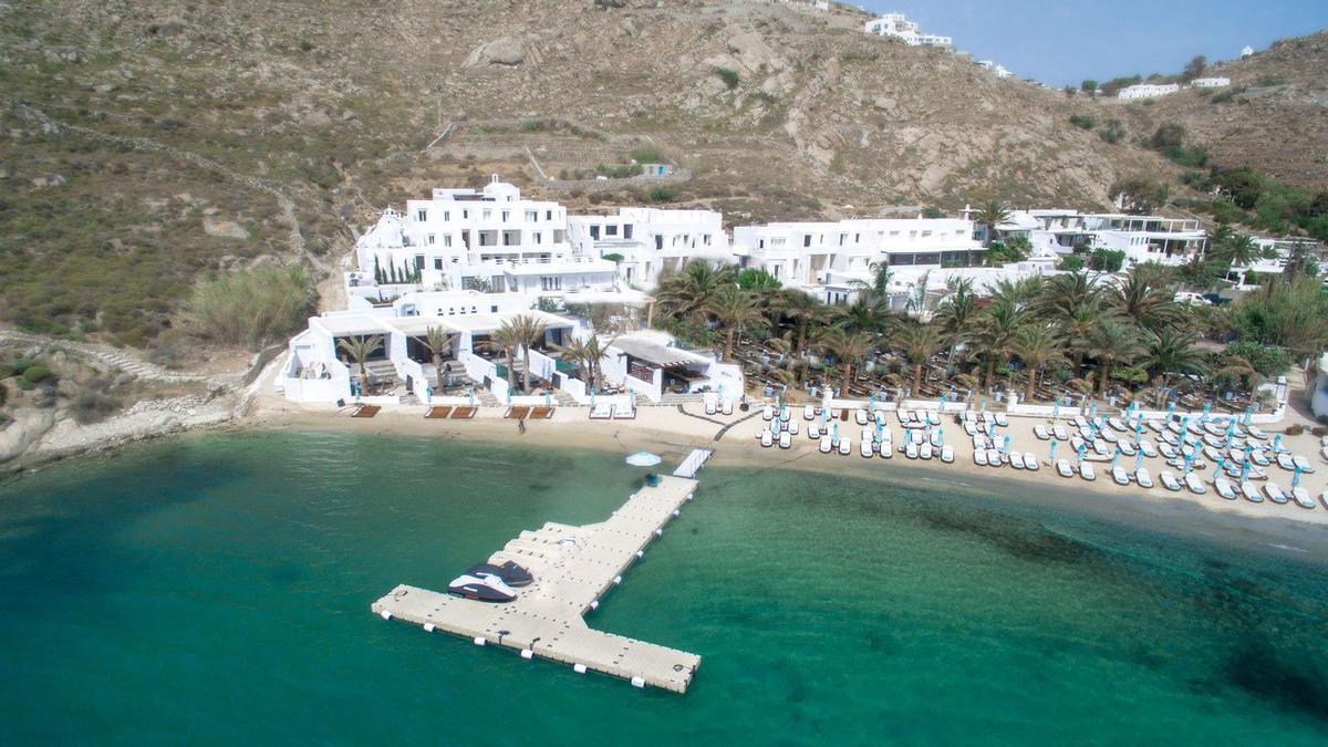The five-star hotel itself is set on Psarou Beach and includes 30 bedrooms and features Aegean architecture together with local stone and aged wood / 