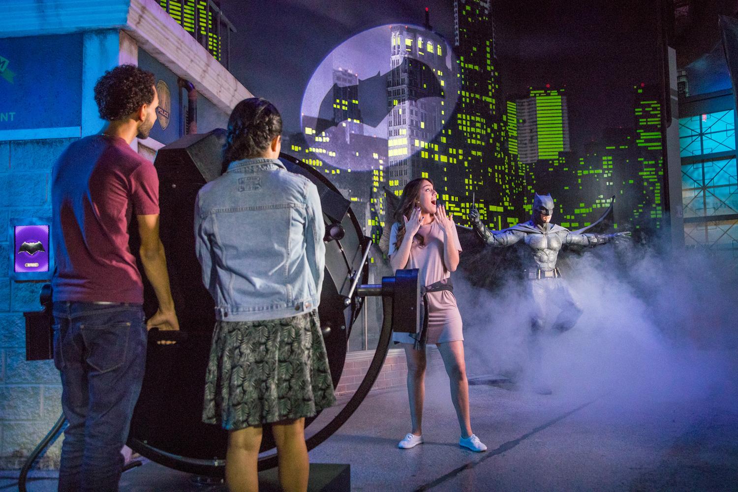 Guests summon Batman using his iconic Bat Signal Guests summon Batman using his iconic Bat Signal