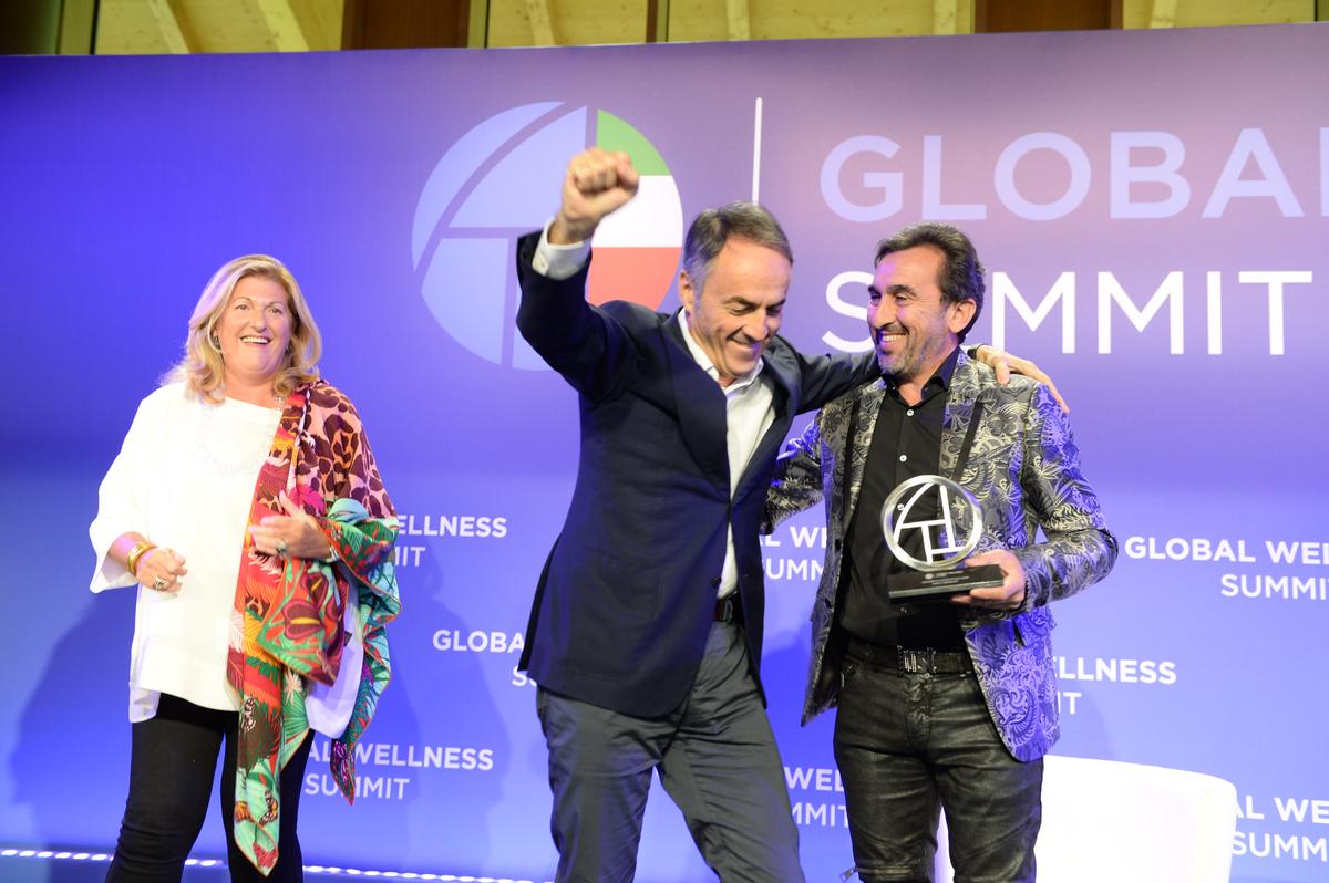 Nerio Alessandri (centre), founder and president of Technogym, rejoices after being presented with the Leader in Innovation award, by Susan Harmsworth (left) and Sammy Gharieni / 