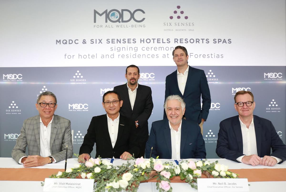 Representatives from MQDC and Six Senses at a signing ceremony at the Research & Innovation for Sustainability Center / Six Senses