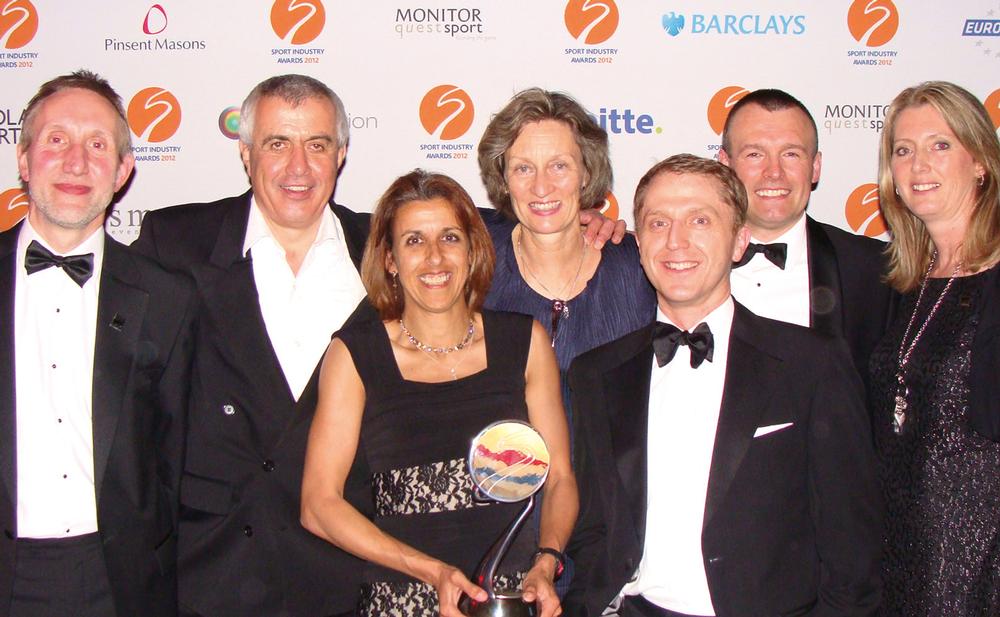 British Triathlon members, including (BTF) CEO Zara Hyde Peters (with trophy centre) and Sarah Springman BTF president (behind), celebrate winning the ‘Sport Governing Body of the Year’ award

