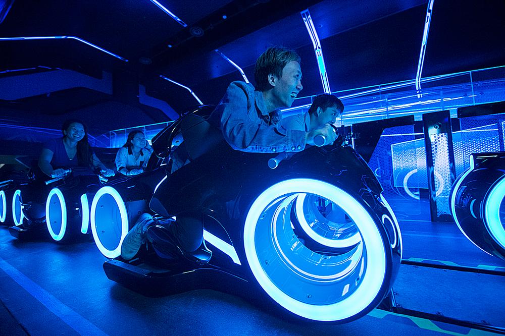 Riding on two-wheeled TRON Lightcycles, guests enter into a game world of lights, projection and effects