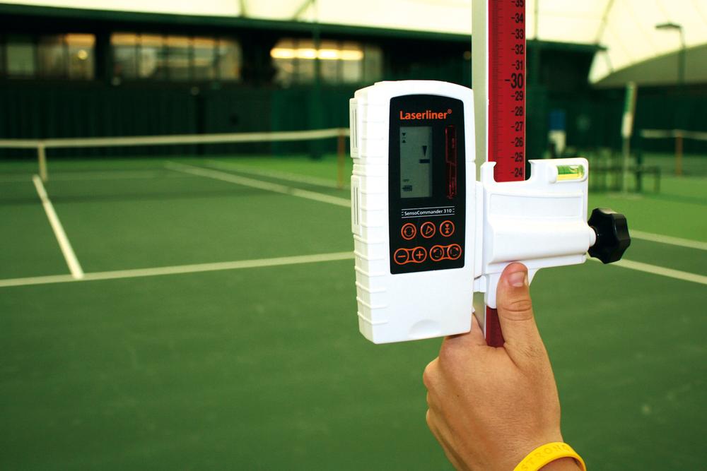 A laser level is used to establish the slope and planarity of the court, during the testing of a court against ITF standards