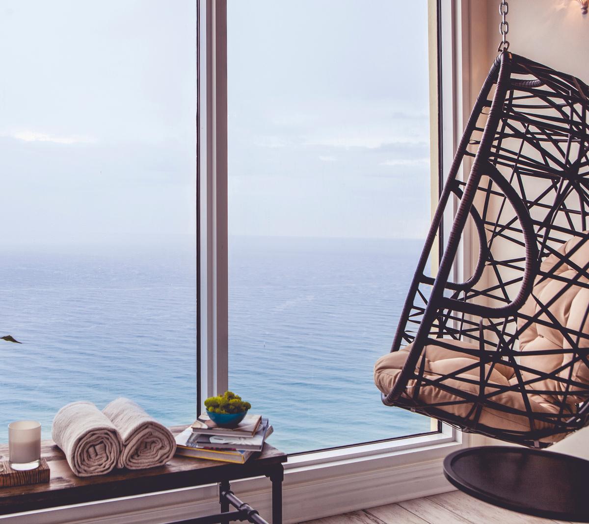 Pure Spa's relaxation room features hanging chairs and ocean views / Pelican Grand Resort Pure Spa's relaxation room features hanging chairs and ocean views / Pelican Grand Resort