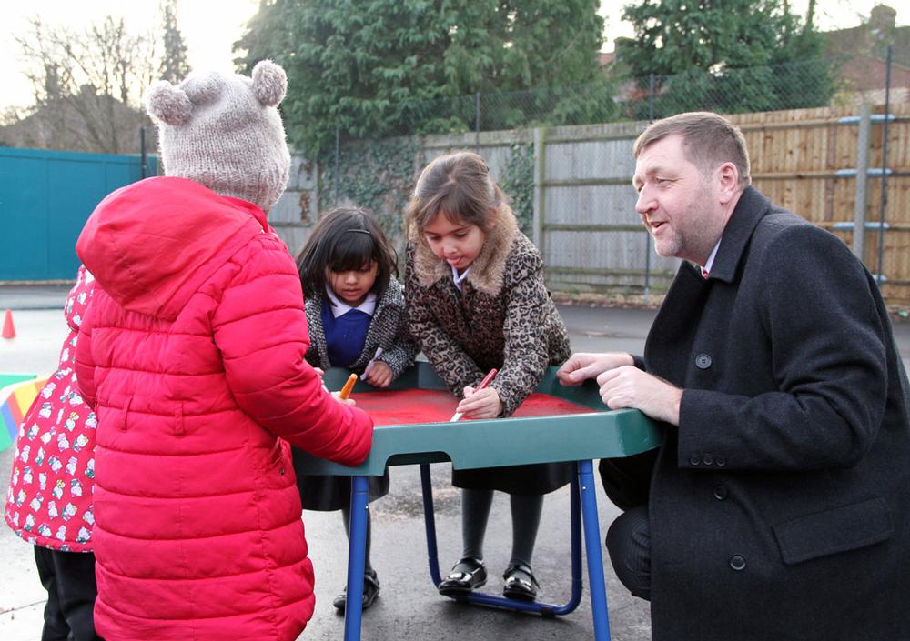 Head teacher John Wrigglesworth oversees a handwriting class