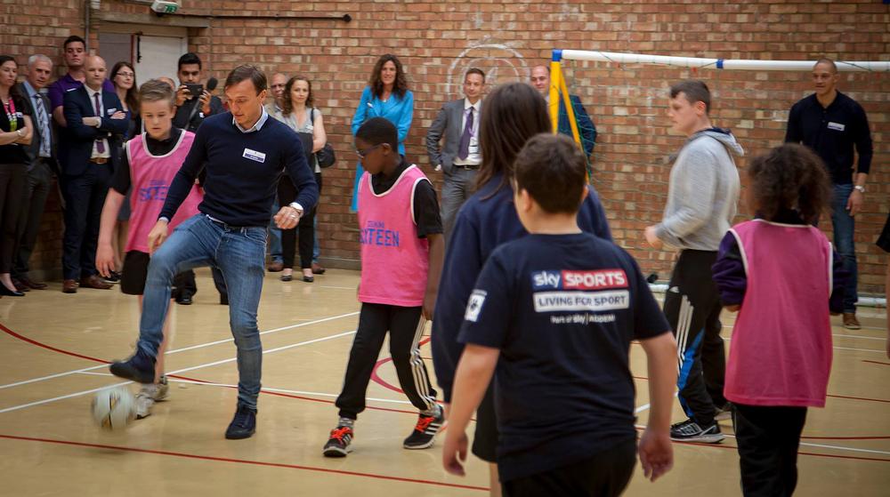 Mark Noble plays a game of football with the kids at Houghton Regis Academy