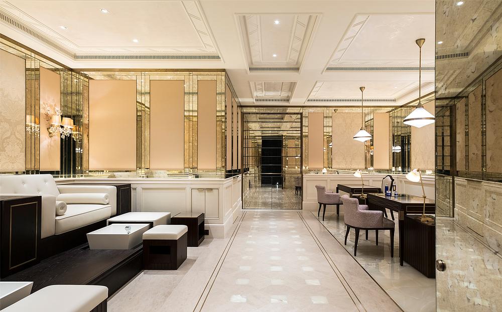 The manicure and pedicure suite features rich details of marble, gold and dark wood