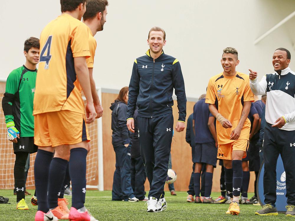 England and Spurs footballer Harry Kane with students from the Education and Football Development Programme