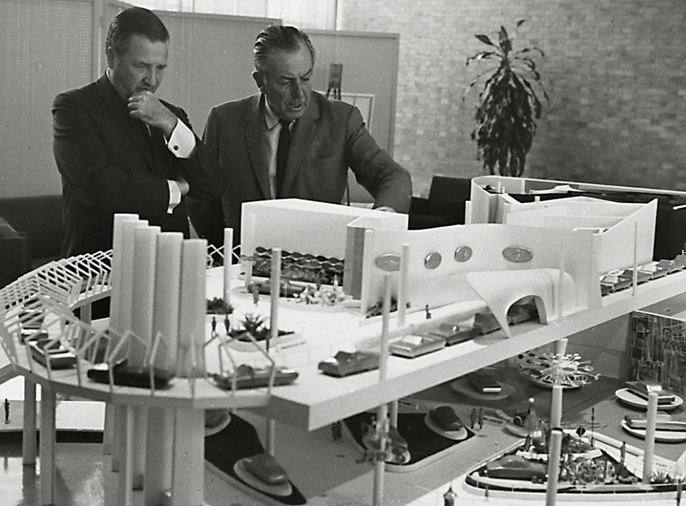 Using a detailed model, Walt Disney shows Ford Motor Company CEO Henry Ford II the features dreamed up for the Ford pavilion / PHOTO: From the collections of The Henry Ford