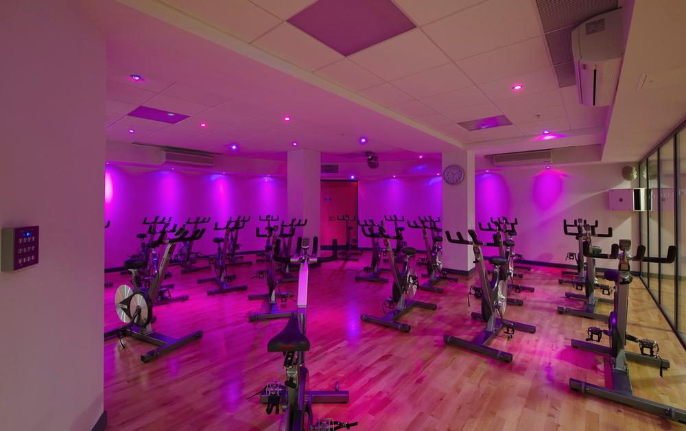 Lighting and a glass wall create ‘theatre’ in Central YMCA’s group cycling studio