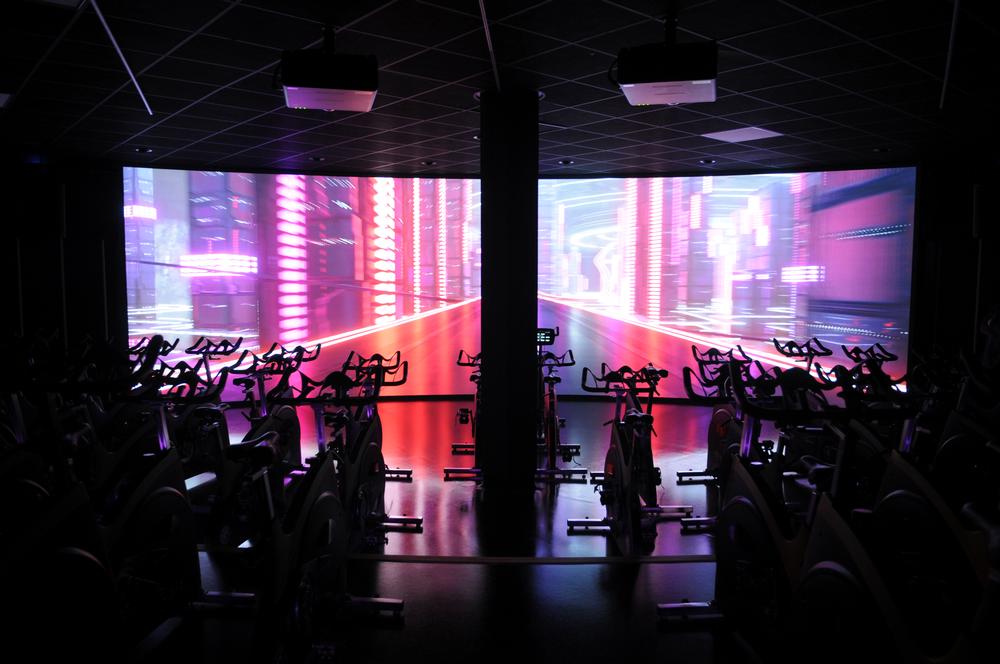 The dedicated Les Mills studios feature cinema-scale screens and sound systems