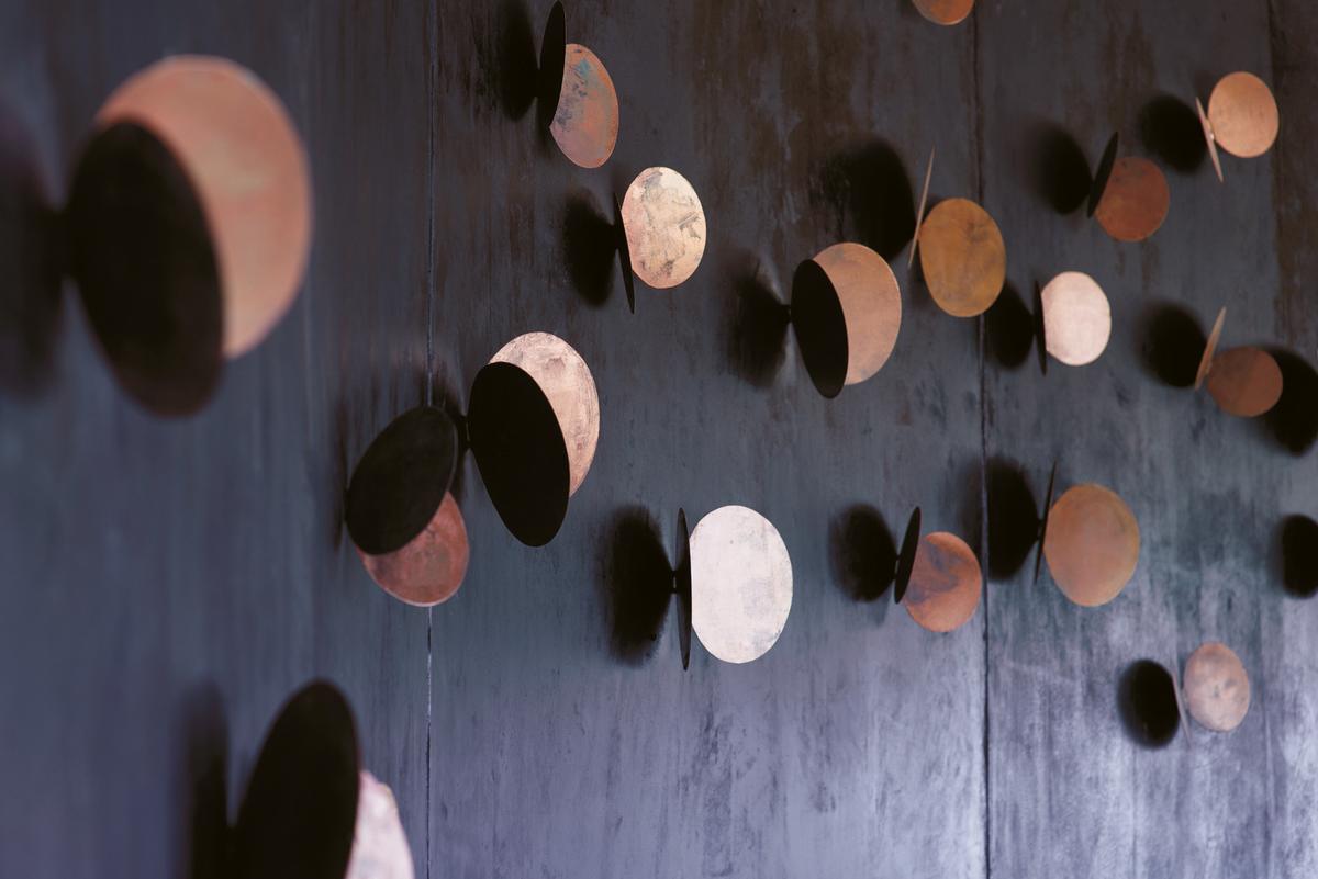 Metal sculptures on the walls resemble swarms of butterflies / Belmond Eagle Island Lodge Botswana