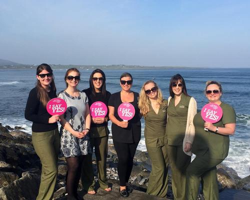 Joanne Berry from Wellness for Cancer poses with the Voya therapist team