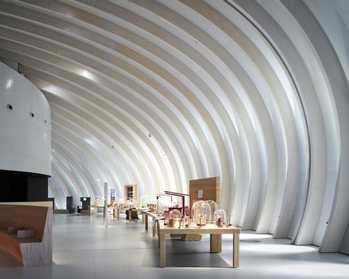 Indoor spaces, materials and scale also reflect a sense of movement, with the wooden archways and undulating walls and ceilings created to allow visitors to pass through the building 'like a flowing river' / Julien Lanoo