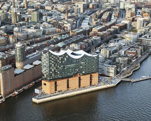 A shimmering glass volume is placed above the exiting Kaispeicher A warehouse, which has been renovated / Maxim Schulz