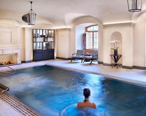 The spa features a sauna, steam bath and vitality pool with waterfall, massage jets and hydrotherapy, surrounded by lounge chairs and a fireplace