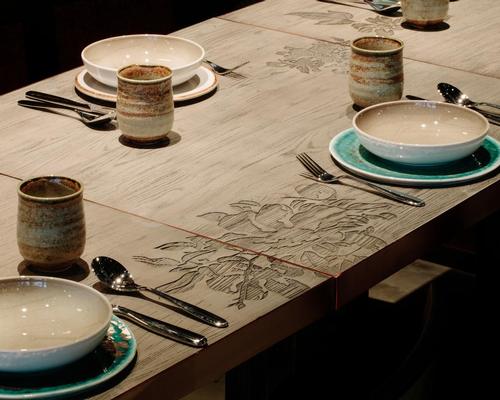 Wooden tables with etched roses pay tribute to Green’s grandmother Rhoda / Joyce Wang Studio