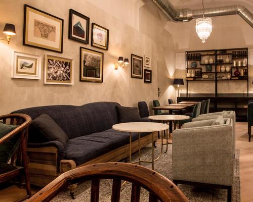 The underground breakfast room features velvet sofas, parquet floors, vintage 1970s lighting, antique doors and an industrial exposed ceiling / Midmost Hotel